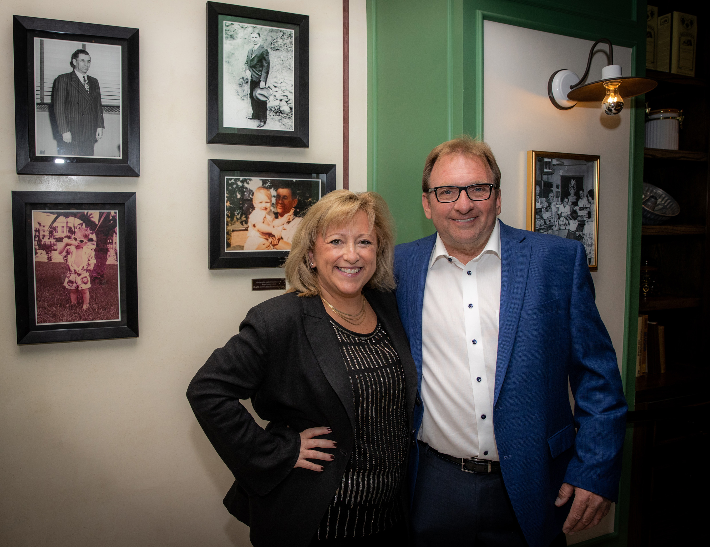 Flamingo Las Vegas founder Meyer Lansky’s grandson, Meyer Lansky II and wife Dani, in front of historical family photos, seen upon entering Bugsy & Meyer’s Steakhouse.