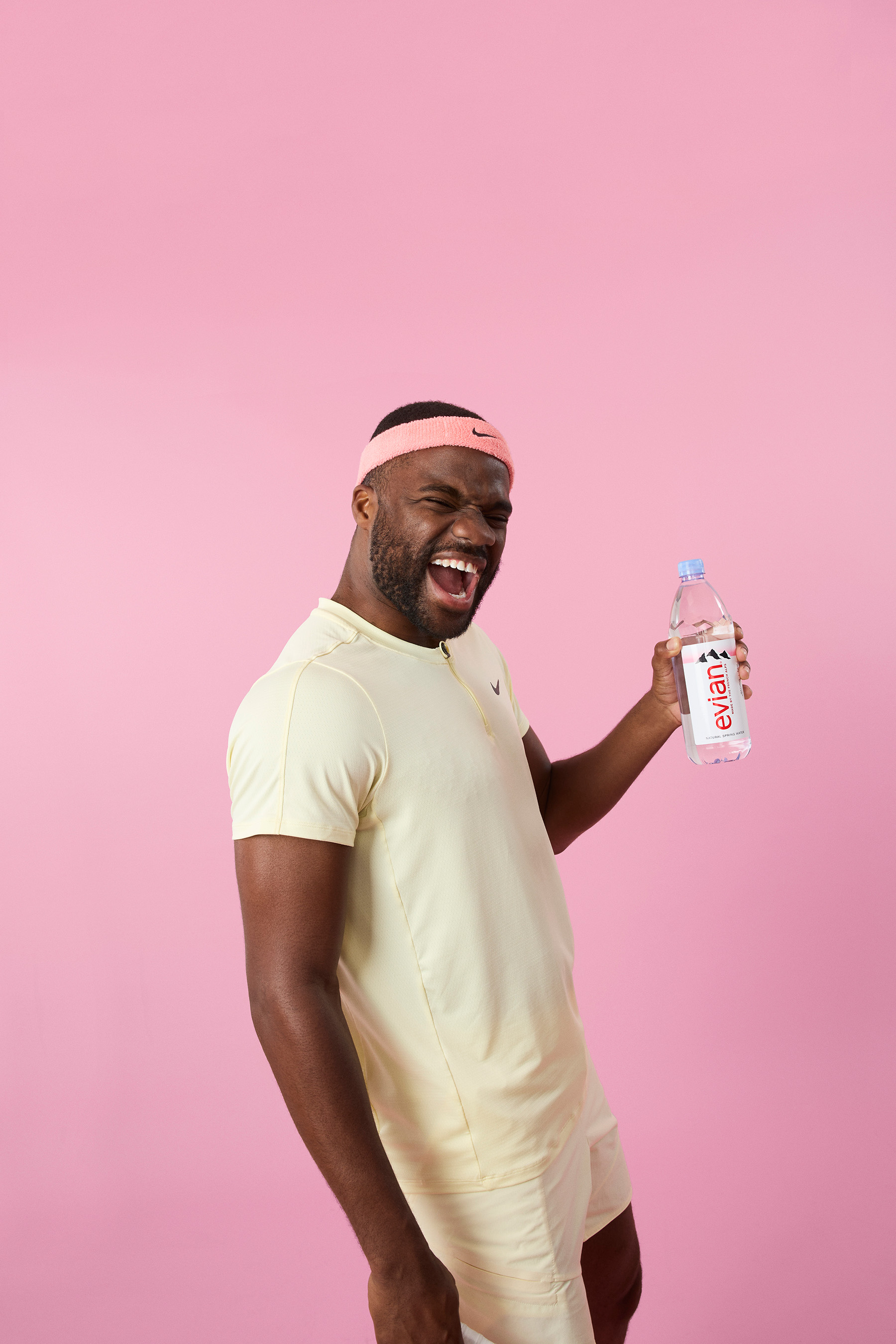 TENNIS STAR FRANCES TIAFOE  holding Evian Water