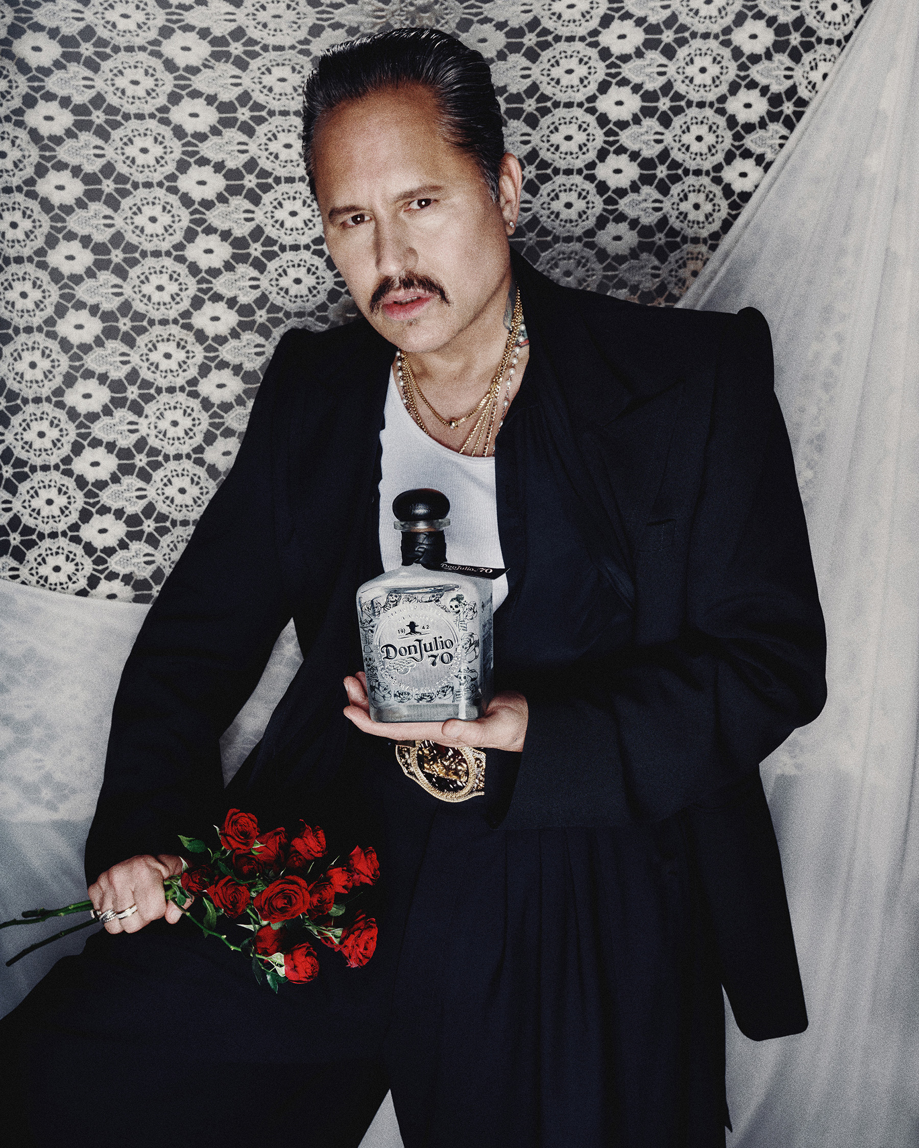 Willy Chavarria holds the Tequila Don Julio 70 Añejo Cristalino Artist Edition bottle.